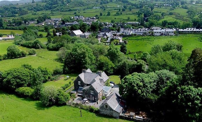 The Coach House with the village of Penmachno in the background. A beautiful location in the Penmachno Valley, near to Betws-y-Coed and within the Sno